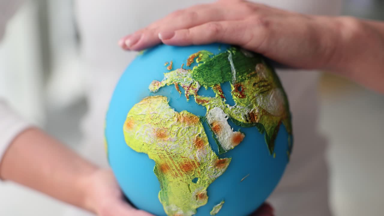 Hands holding a globe representing environmental care