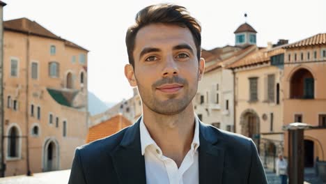 man in suit smiling in european city