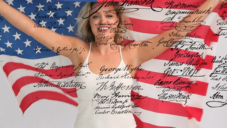 Woman holding an American flag with written declaration of independence of the United States