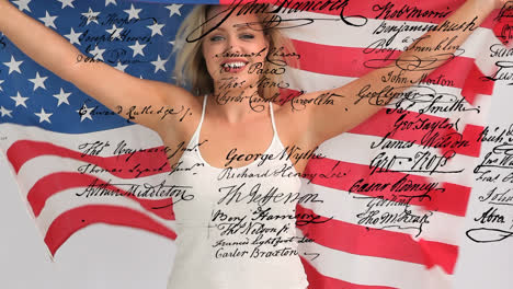 woman holding an american flag with written declaration of independence of the united states