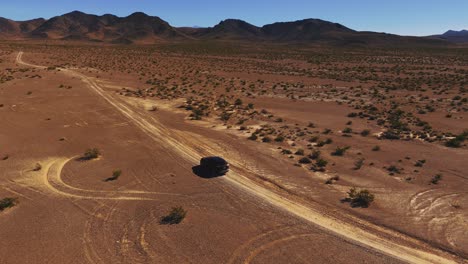 Car-driving-on-desert-dirt-road-off-road-in-Nevada-close-to-Death-Valley