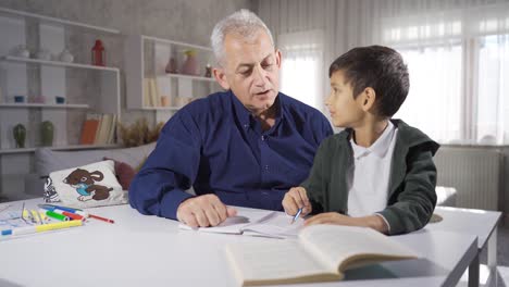 father looking after and helping his son who is studying.