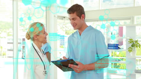 animation of medical data processing over caucasian male and female doctors discussing at hospital