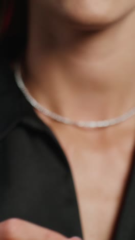 close-up of a woman wearing a silver necklace