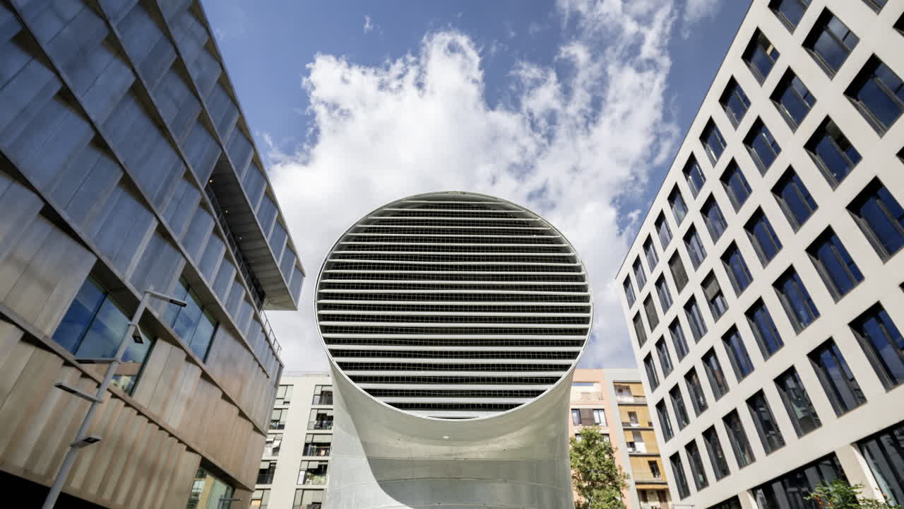 Old factory and industrial complex and air vent with passing clouds