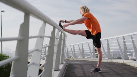 sporty caucasian man training on a bridge