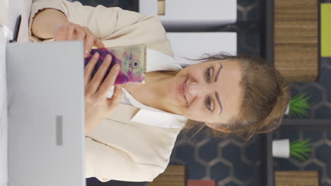 Vertical-video-of-Business-woman-liking-mobile-application-from-phone.