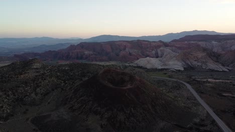 Aerial-shot-orbiting-Santa-Clara-volcano-in-the-mountains-of-Utah-at-sunset