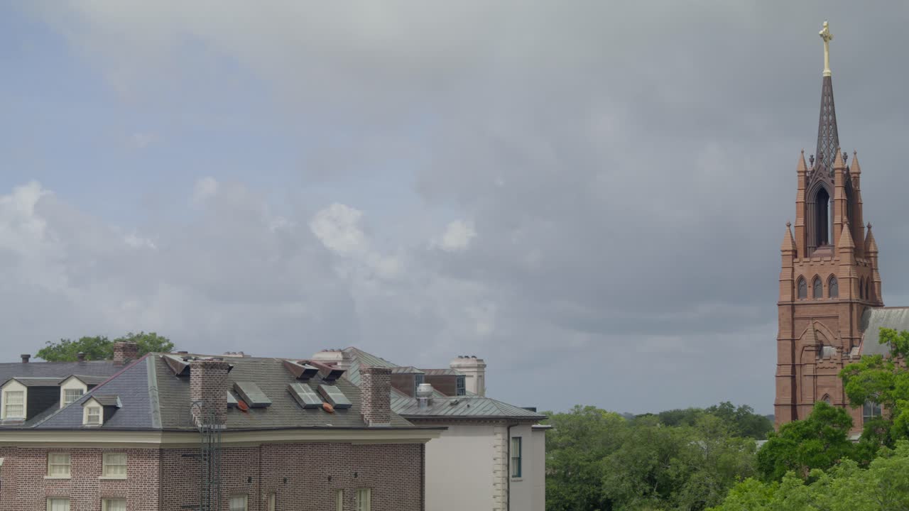 Pan left and right view of downtown Charleston SC showing the historic church and surrounding palm-lined streets