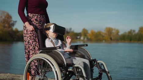 girl wearing vr headset plays game sitting in wheelchair