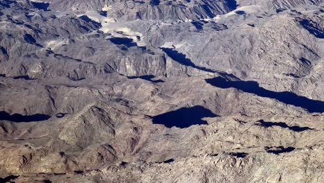 Texture-of-mountain-range-aerial-drone-view-geographical-hills-dry-earth-tones,-colorful-background,-natural-environment,-slow-motion-panoramic-top-down