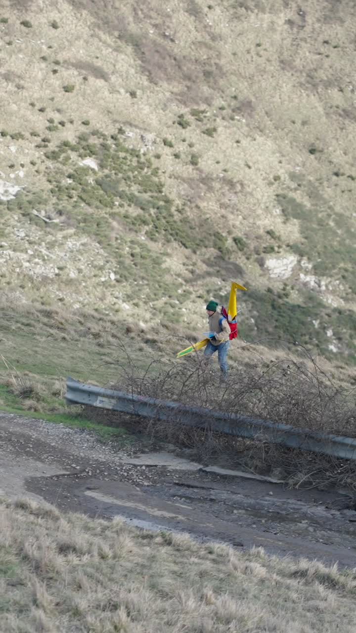 Person with drone on hillside
