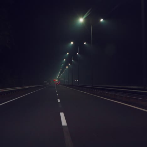 car is driving quickly along the highway in the dark. night travel by car. movement speed