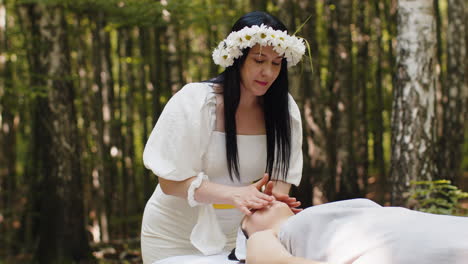 woman giving massage in a forest