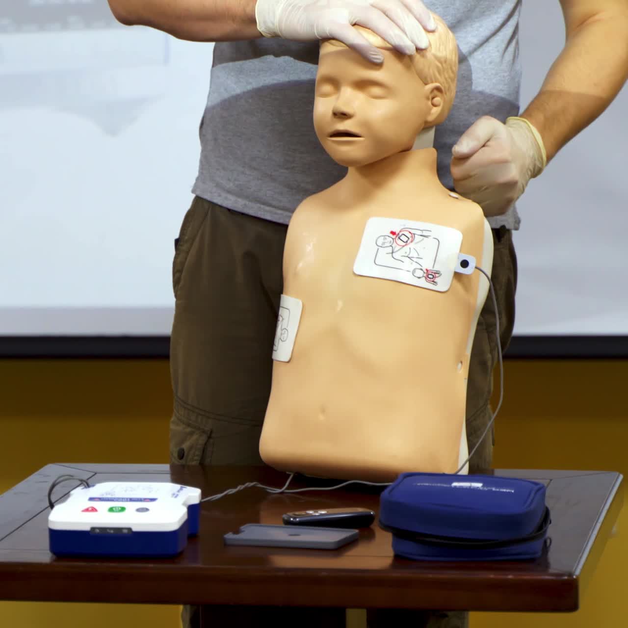 Medical training on a manikin. Instructor demonstrating the procedure of first aid on a dummy. Cardiopulmonary resuscitation.