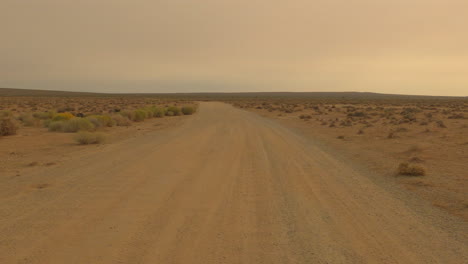 Driving-down-a-Mojave-Desert-dirt-road-completely-barren-from-drought