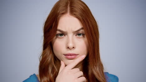 doubt woman getting an idea in studio. closeup curious girl thinking indoors