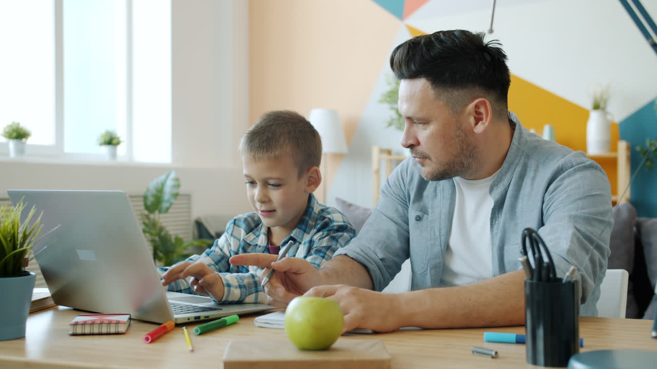 Father and son learning together at home