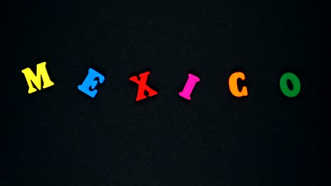 word "mexico" formed of wooden multicolored letters. colorful words loop.