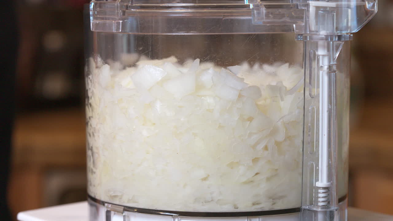 Pulsing the food processor to produce perfectly chopped onions for a homemade recipe