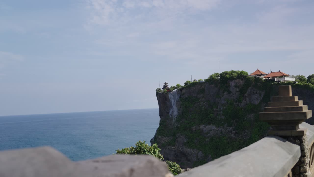 Sacred buildings on top of cliff near ocean in Indonesia of Pura Luhur Uluwatu, motion view