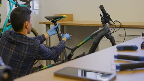 man repairing bicycle seat in workshop 4k