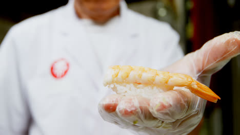 Male-chef-holding-rice-with-seafood-in-kitchen-4k