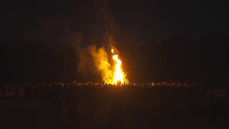 hoguera frente a una gran multitud de personas por la noche, reunión tribal, paganismo, espiritualidad, reunión de arco iris de luna llena