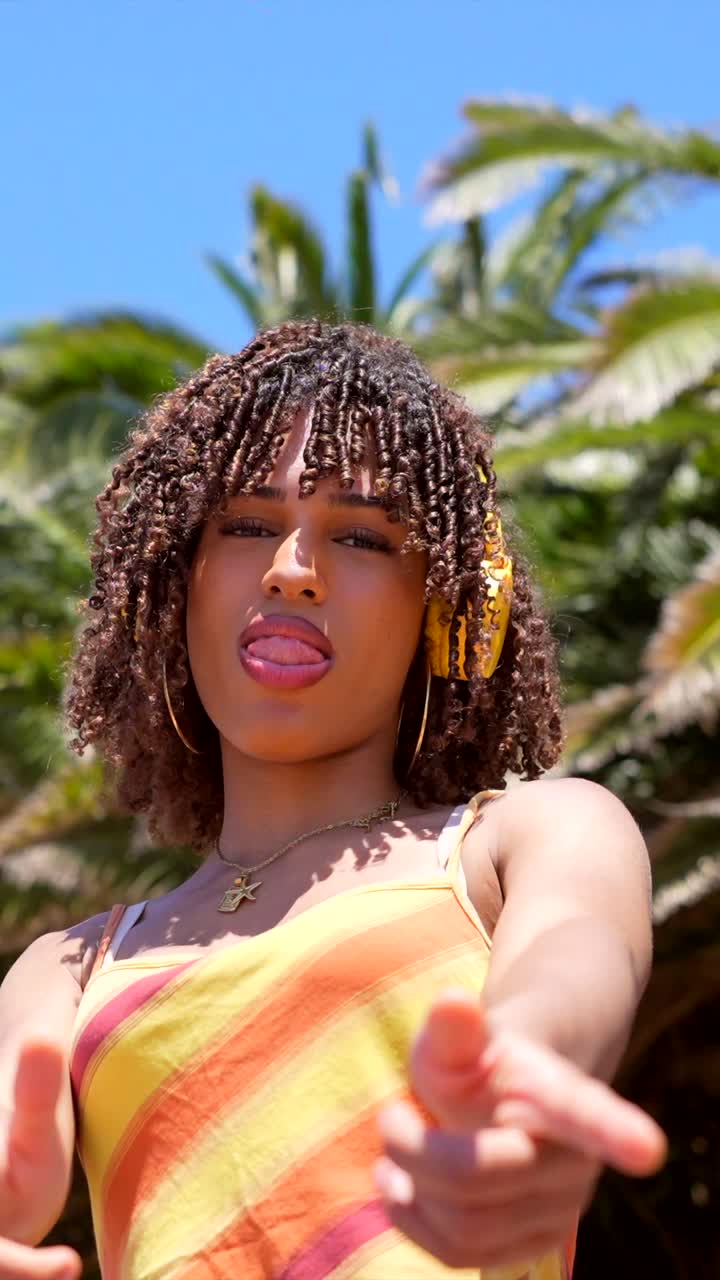 Woman with curly hair enjoying a summer day outdoors