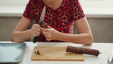 woman preparing sausage