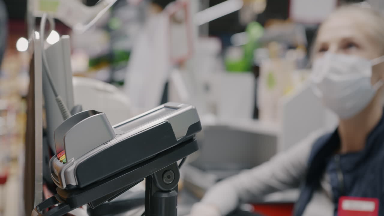 Grocery store checkout with masked cashier