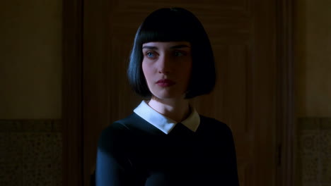 portrait of a woman with a bob haircut and white collar dress