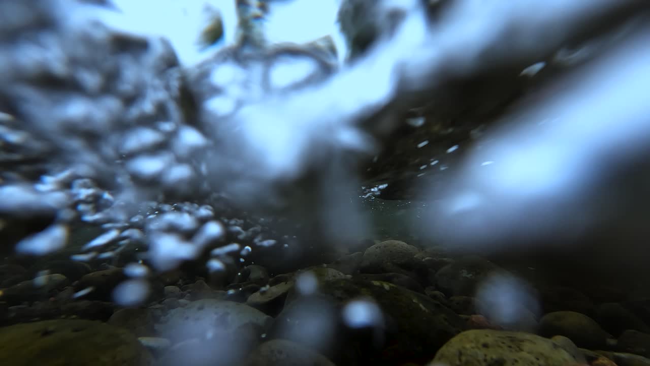 Underwater view with flowing water in a river in Mexico at a cloudy day