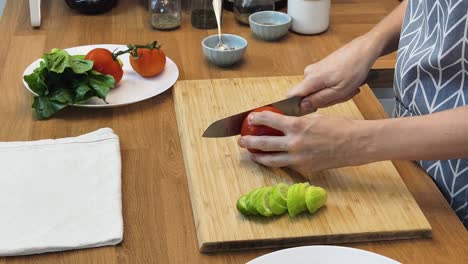 preparing a salad with tomatoes and cucumber