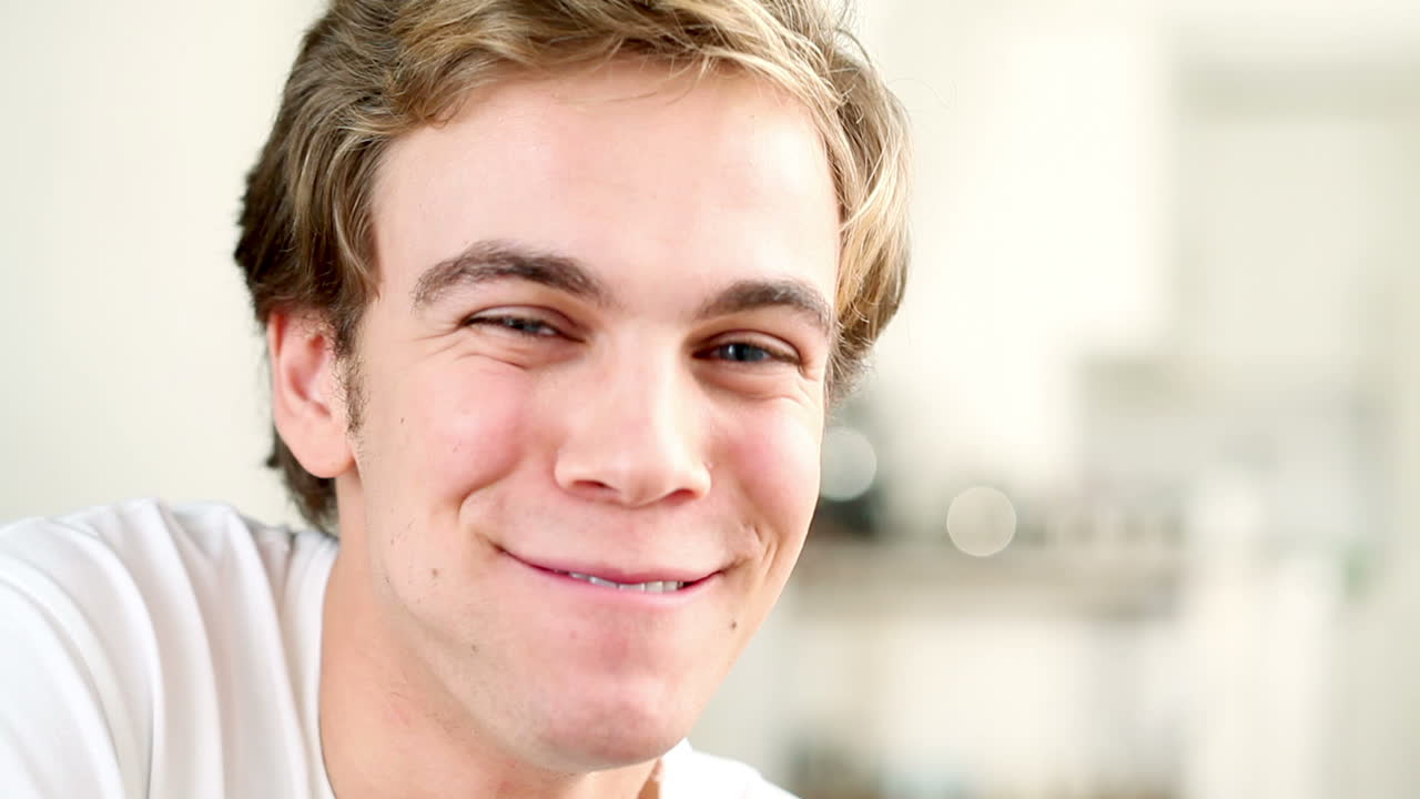 매력적인 젊은 남자가  ⁇ 드폰으로 채팅하고 있습니다.