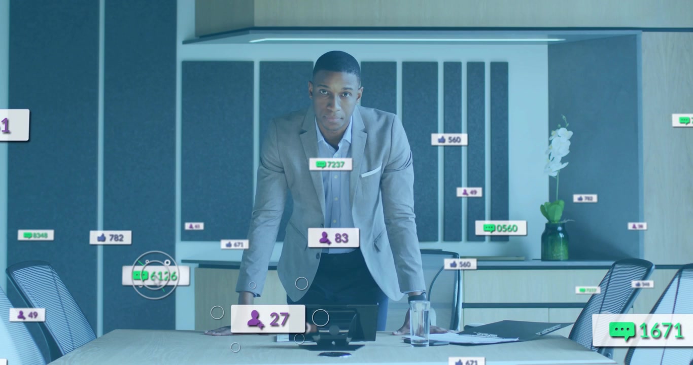 Man scanning documents and initiating engagement icons above table tracking business metrics
