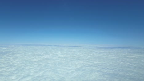 pov hypersonic flight over a blanket of white clouds