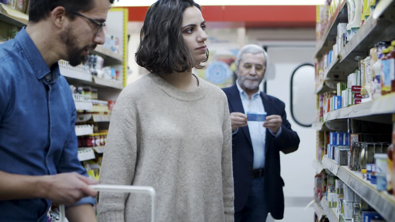 Customers choosing products in supermarket