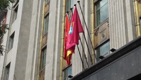 flags of madrid and spain flying outside ayuntamiento de madrid building