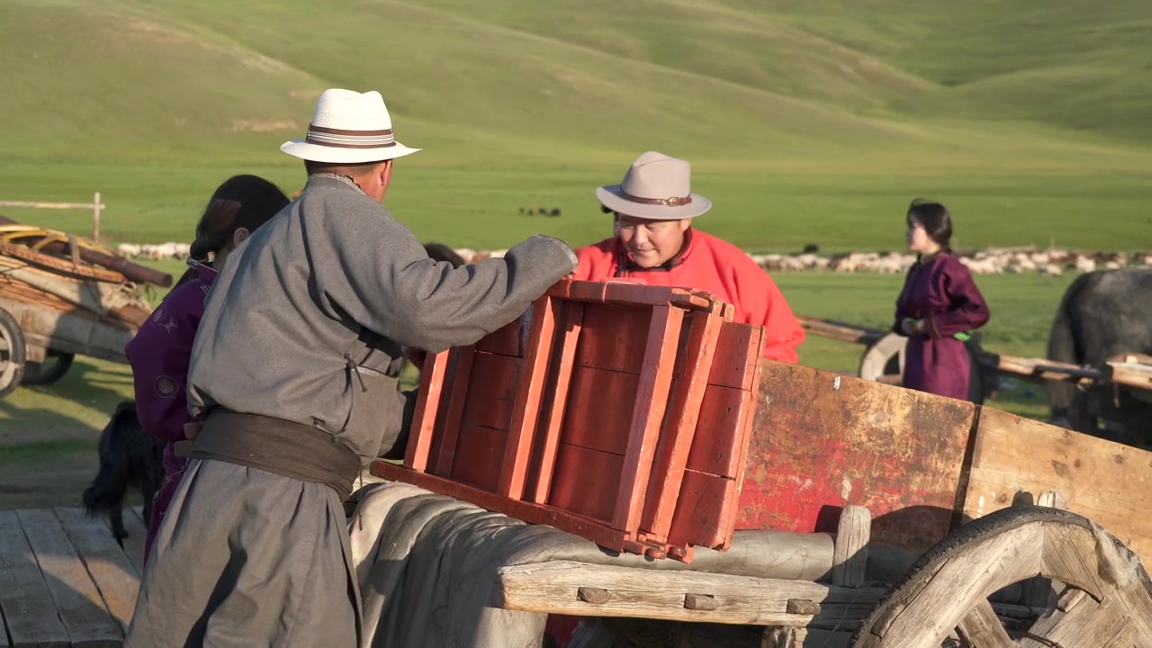 Mongolian Nomadic Family Assembling Wooden Cart on Steppe