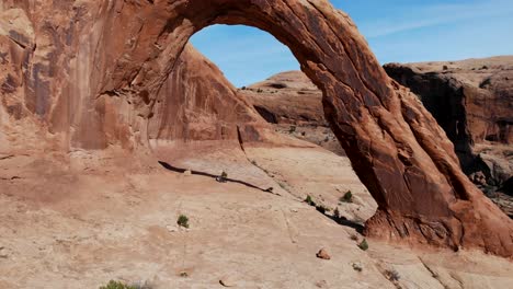 A-high-flying-drone-shot-of-the-Corona-Arch,-a-massive-natural-sandstone-arch-located-in-a-side-canyon-of-the-Colorado-River,-just-west-of-Moab,-Utah