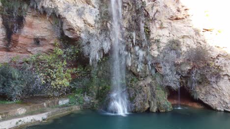 tall small waterfall stream of water, valencia region of spain national park