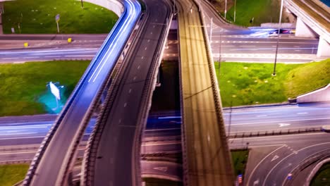 night timelapse aerial view of a freeway intersection traffic trails in night moscow