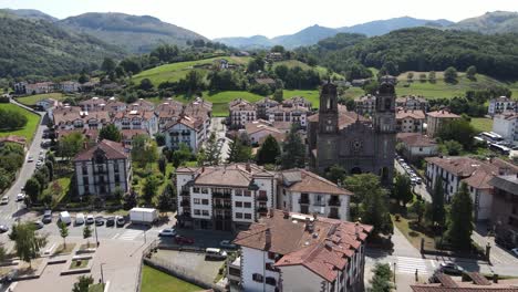 Pan-right-shot-of-daylight-traffic-in-a-busy-square-of-town-Elizondo,-capital-of-Baztan-Valley