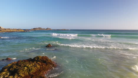 Amazing-rocky-beach-coastline-in-NSW-Australia,-aerial-dolly-view-over-waves