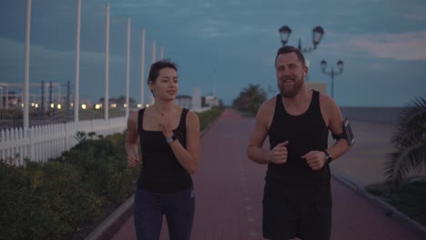 couple running at twilight on the beach