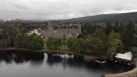 Slow-pan-over-Loch-Ness-viewing-Fort-Augustus-Abbey,-aerial