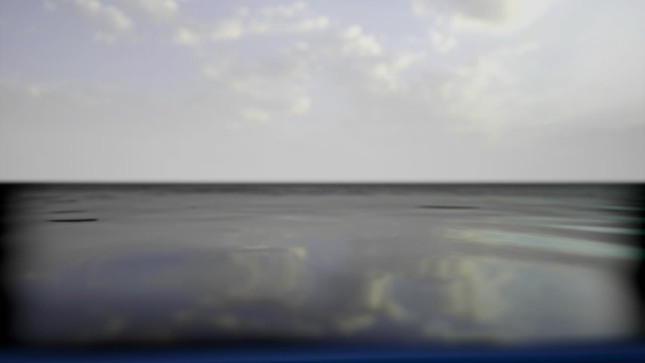 Calm waters reflect clouds under expansive sky at tranquil coastal location