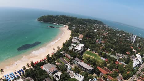high aerial shot of marvelous island heaven on earth, white sandy beach on blue ocean, sri lanka