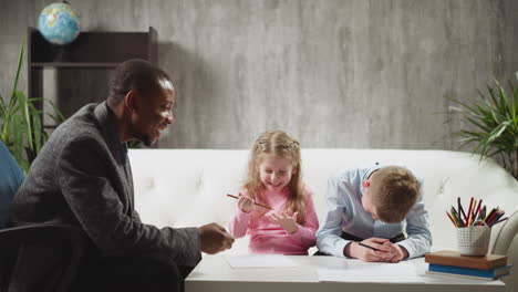 african-american english teacher talks to happy children